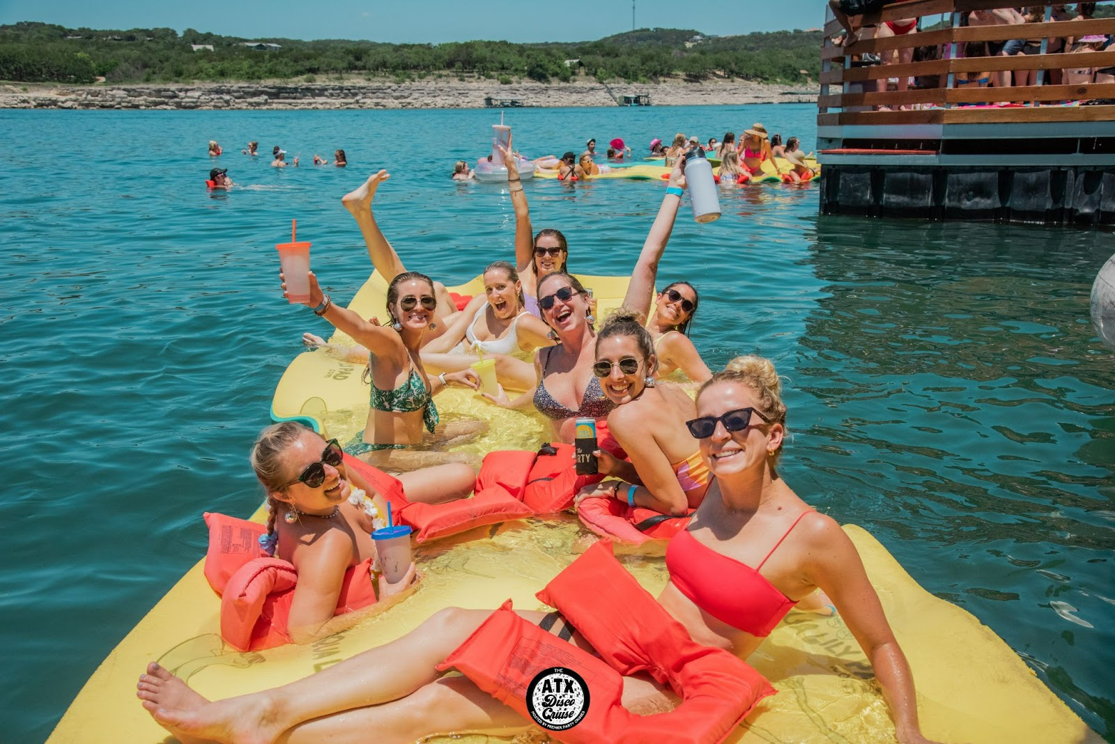 Bachelorettes floating in Premier Party Cruises Lili pads in a Bachelorette Party In Austin