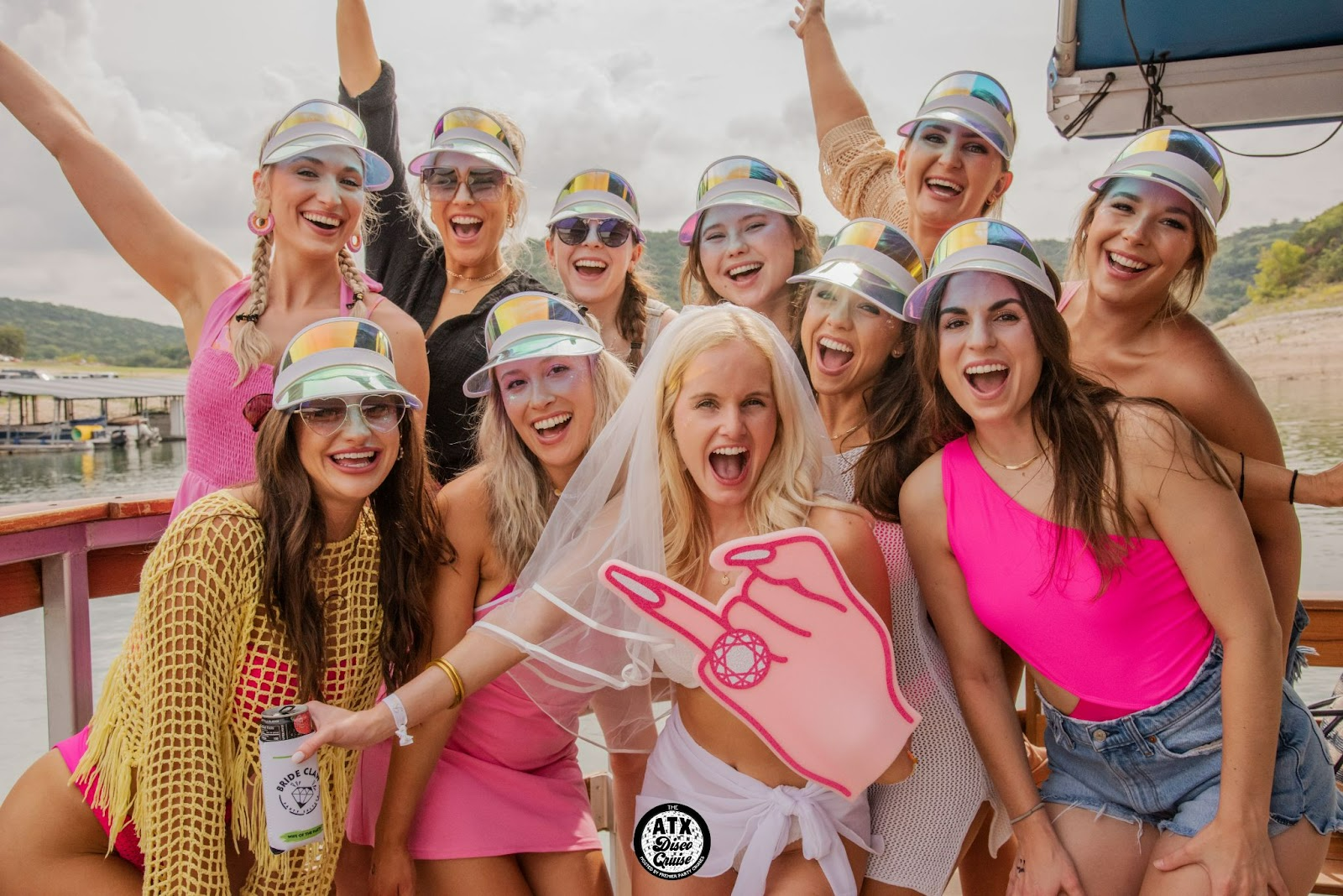 Group of excited women celebrating on Premier Party Cruises boat during a bachelorette party in Austin